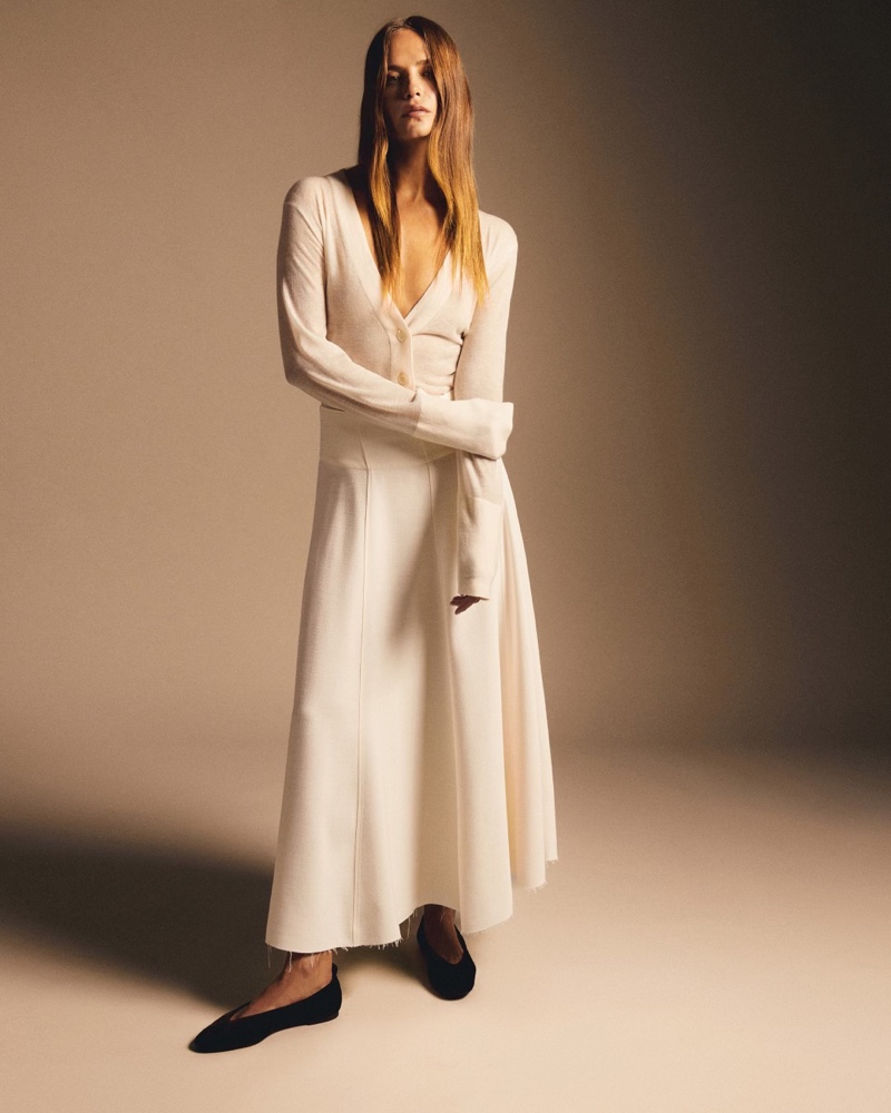 Dressed in all-white, Natasha Poly wears Massimo Dutti cardigan and long skirt pairing.