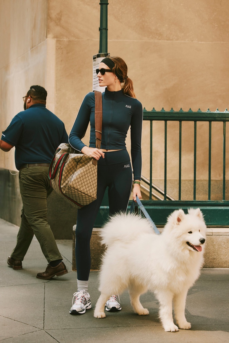 Altyn Isabella goes on dog walk while wearing Sporty & Rich's Wall Street Drop.