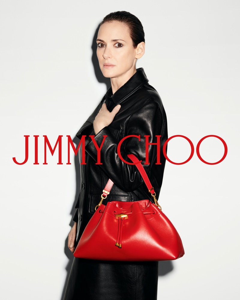 Standing out with red, Winona Ryder poses with Jimmy Choo's Cinch bag for the fall 2024 season.