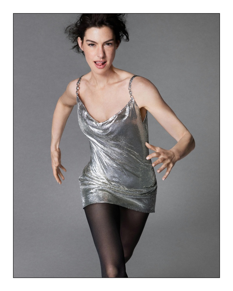 Hitting a pose, Anne Hathaway models a metallic mesh slip dress in Versace Icons campaign.