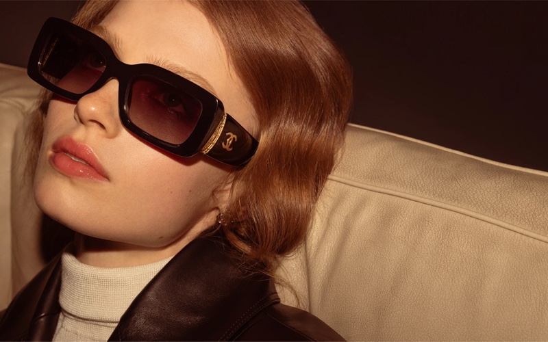 Ella Mccutcheon  models rectange sunglasses for Chanel eyewear's fall 2024 collection.