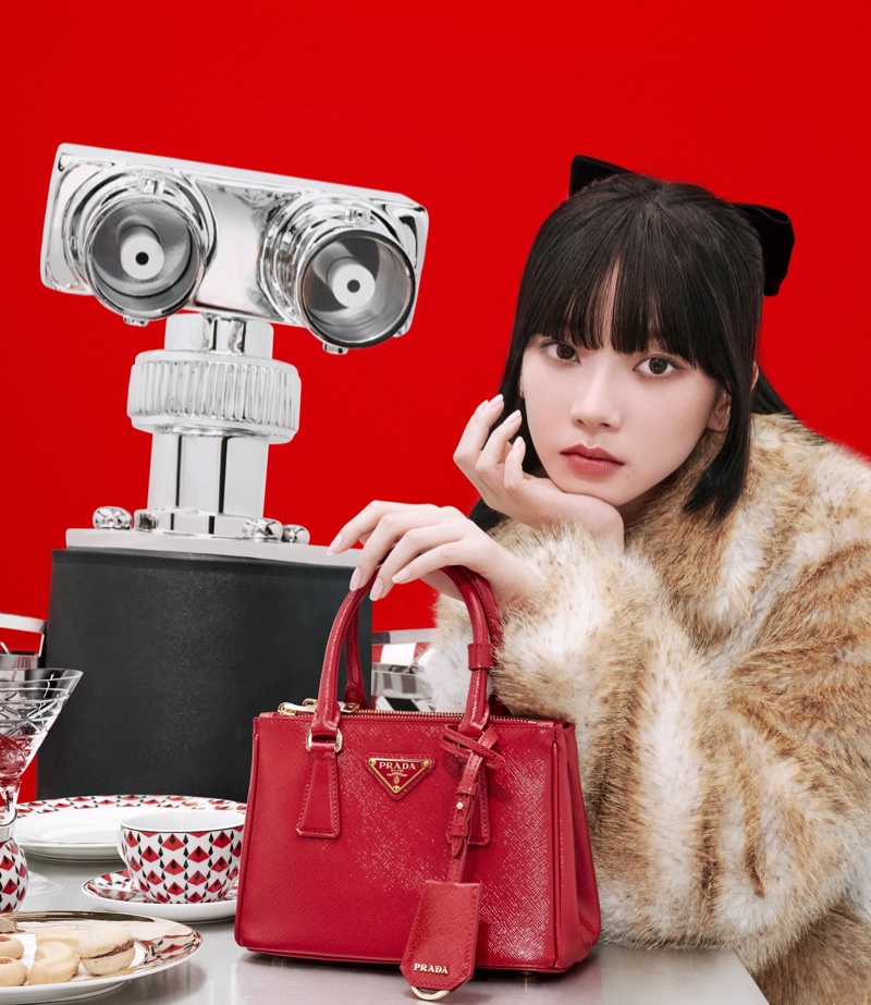 KARINA poses with a red handbag in Prada's holiday 2024 campaign.