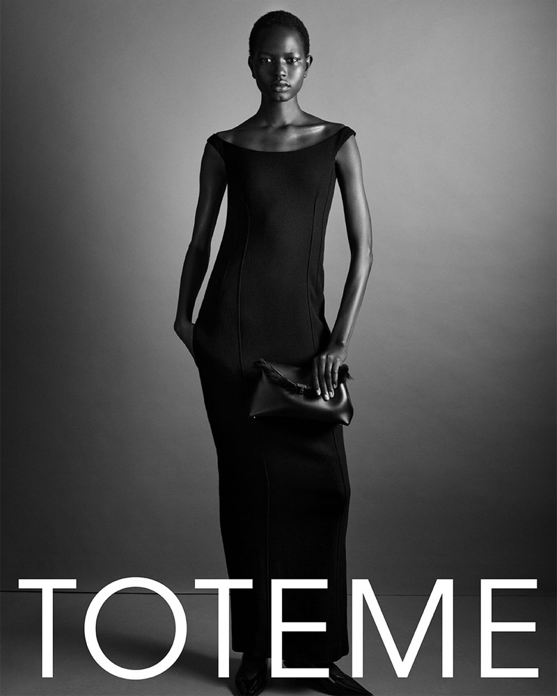 Nyaduola Gabriel models curved off-the-shoulder dress for Toteme's fall-winter 2024 campaign.