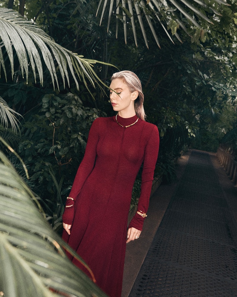 Modeling a red dress, Vanessa Kirby shows off layered Cartier jewelry.