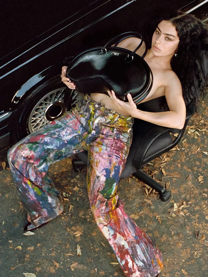 Charli XCX models paint-splattered jeans for Acne Studio's spring 2025 ad.