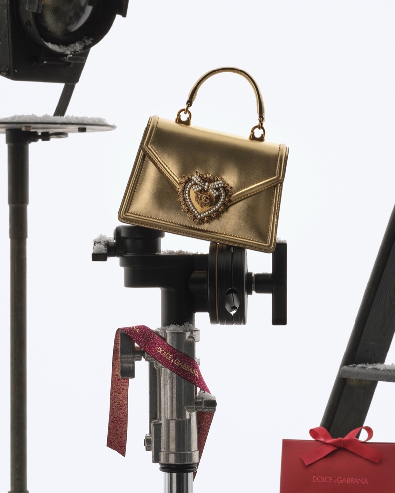 Dolce & Gabbana highlights the Devotion bag in gold for the holiday season.