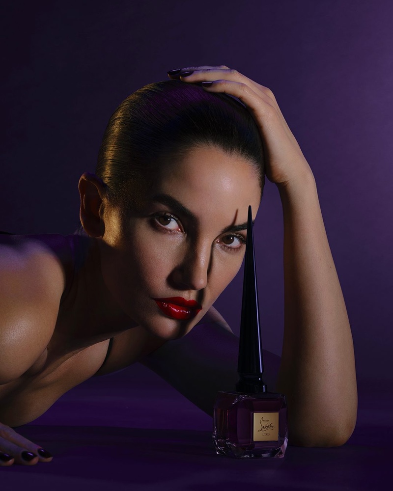 Awash in purple, Lily Aldridge poses with Louboutin Fétiche L'Iris eau de parfum bottle.