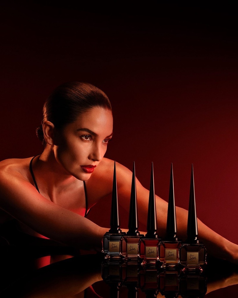 Lily Aldridge models alongside the Louboutin Fétiche fragrance collection.