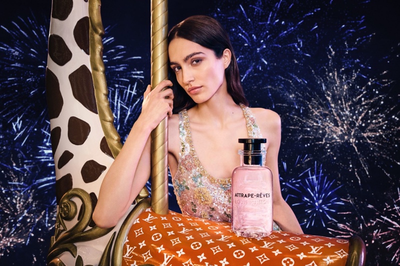 Sara Caballero poses with Louis Vuitton's Attrape-Rêves fragrance in the brand's Holiday 2024 ad.