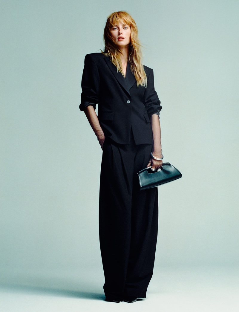 Rianne van Rompaey models a wool blazer and pleated pants from Mango's winter 2024 party collection.