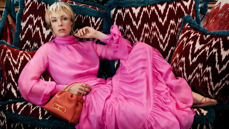 Edie Campbell looks pretty in pink for CH Carolina Herrera's Holiday 2024 campaign.