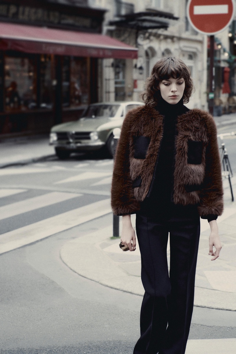 Alix Bouthors shows off Zara’s faux fur jacket, turtleneck sweater, and wide leg pants.