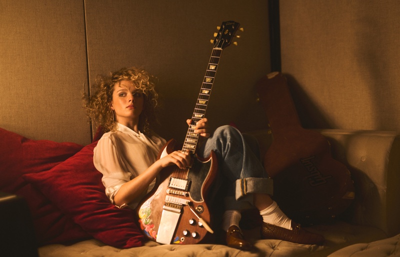 Posing with her guitar, Grace Bowers keeps it causal in a blouse and jeans.