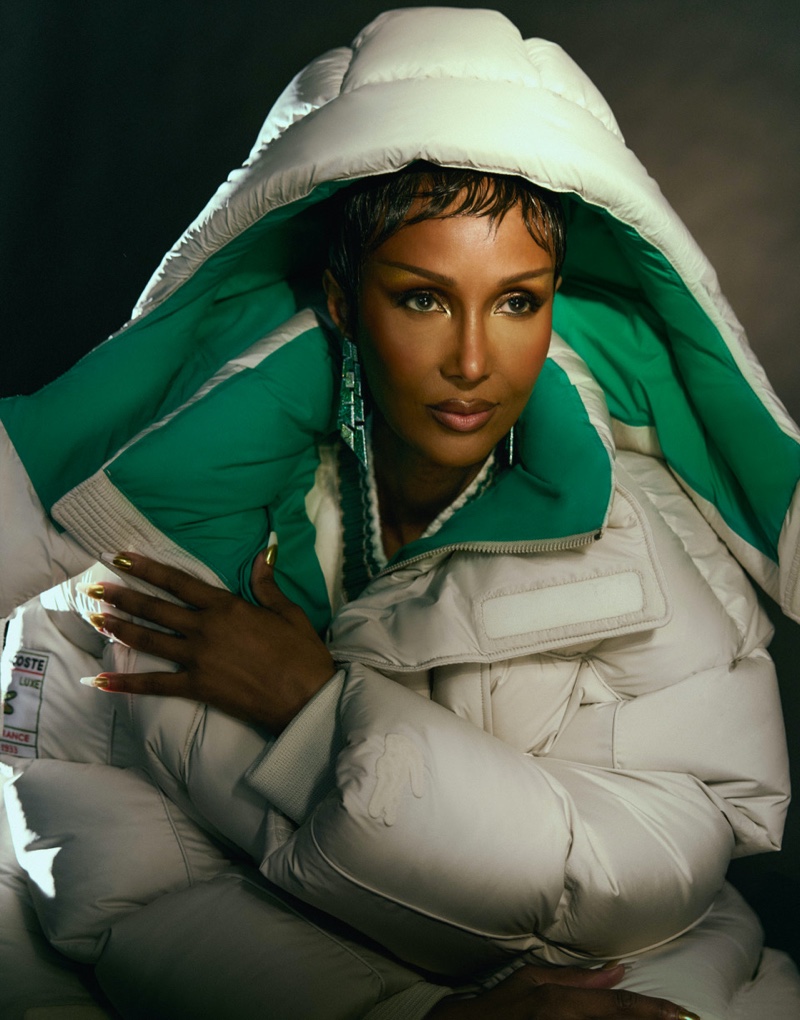 Layered up, Iman wears a Lacoste puffer and Chopard earrings.