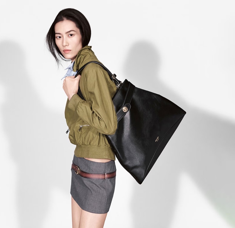 Liu Wen models new season bags in Prada's spring 2025 ad.