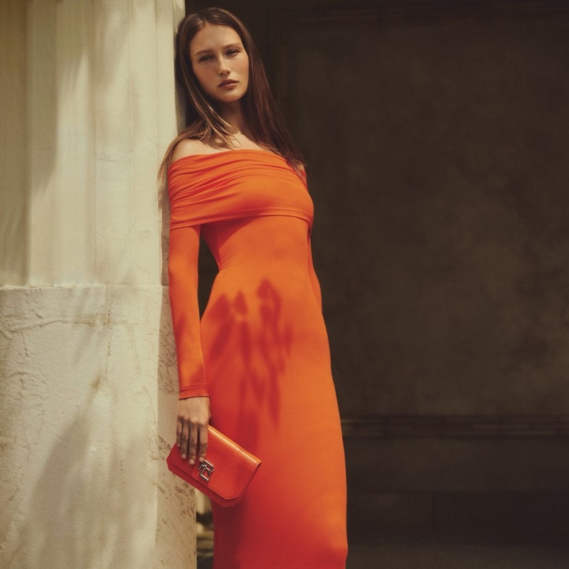 Vika Evseeva wears a Ralph Lauren off-the-shoulder dress.