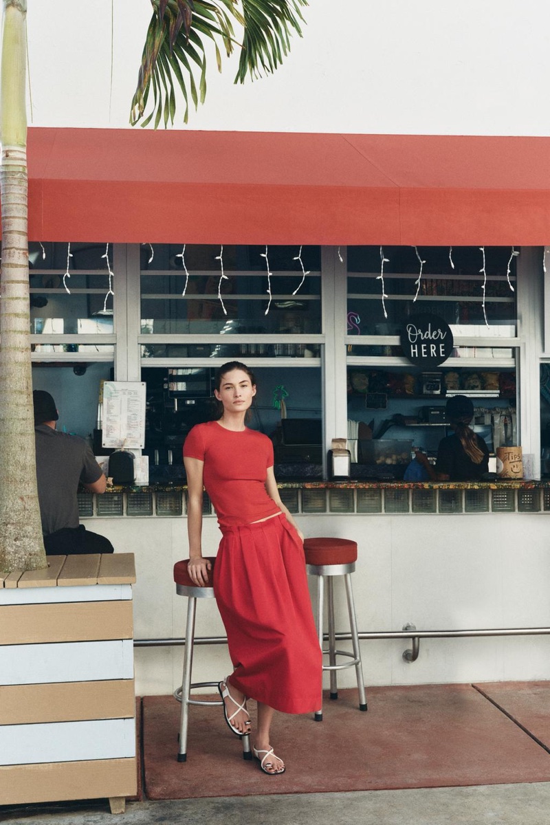 Grace Elizabeth models red shirt and pleated skirt look from Zara.